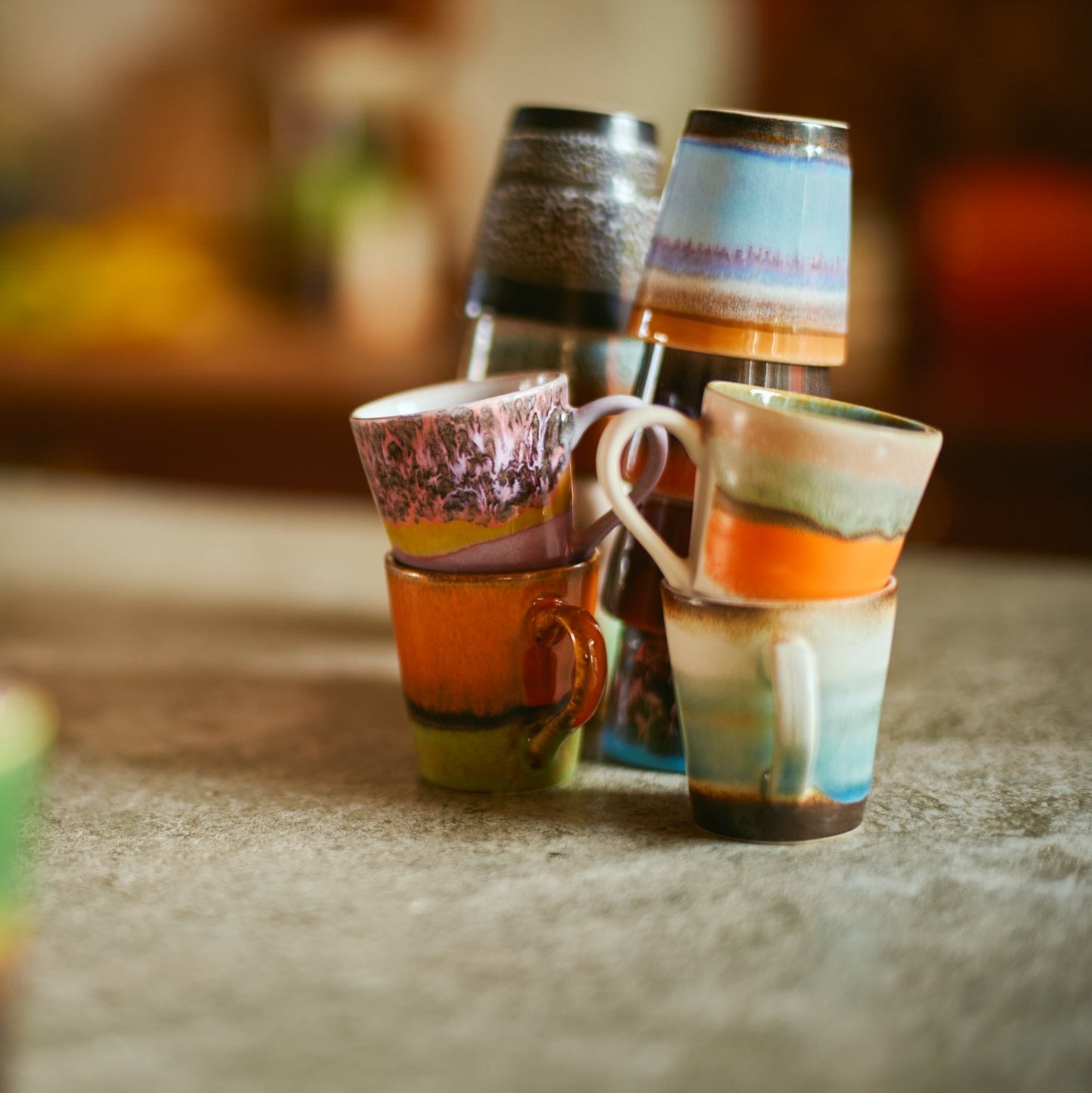 On a marble counter top two different sets of hkliving ristretto and espresso mugs are stacked together