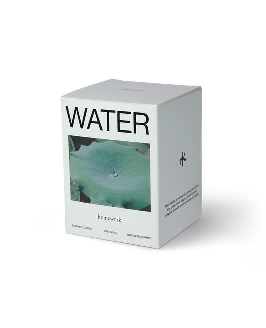 Homework water scented candle packaging, a white box with water written across the top, under is a landscape image of a water Lilly pad with a single water drop on it. Then the brands name homework is spelt in lowercase letting under the image