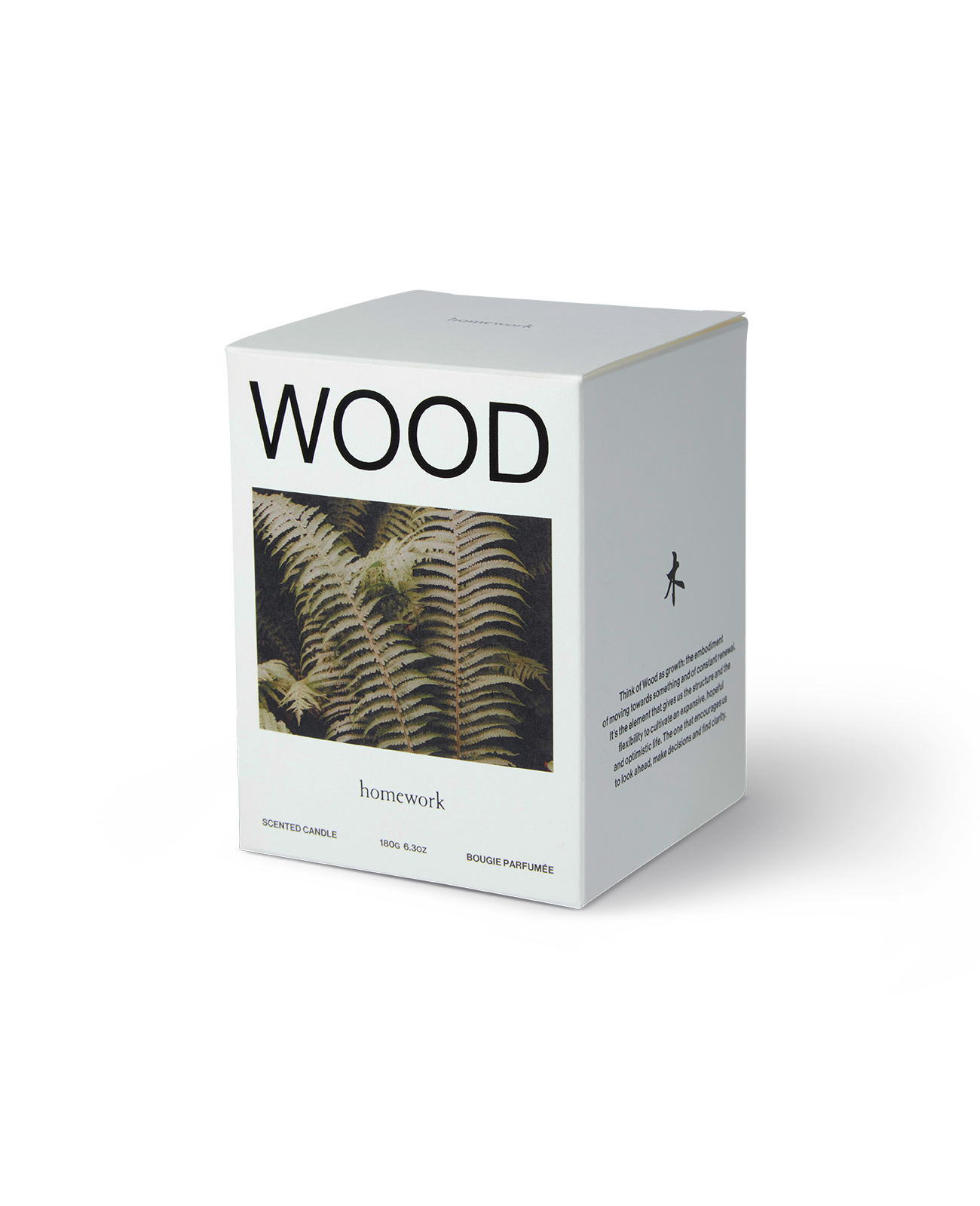 Homework wood candle packaging, a white box with wood spelt across the top, under an image of a brownish green Fern plant an the brands name in lower case lettering under the photo