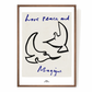 An image depicting Hotel Magique Love,Peace and Magique A3 print. The background is beige. The birds are painted in black. “Love Peace and Magique” is written in dark blue. The print is frames with a wooden border. 