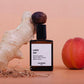 Perfume bottle labeled 'culot the' by Versatile Paris with a peach and ginger root on a beige background