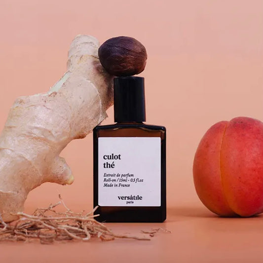Perfume bottle labeled 'culot the' by Versatile Paris with a peach and ginger root on a beige background