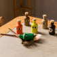 Colorful bottle stoppers with face designs on a wooden table.