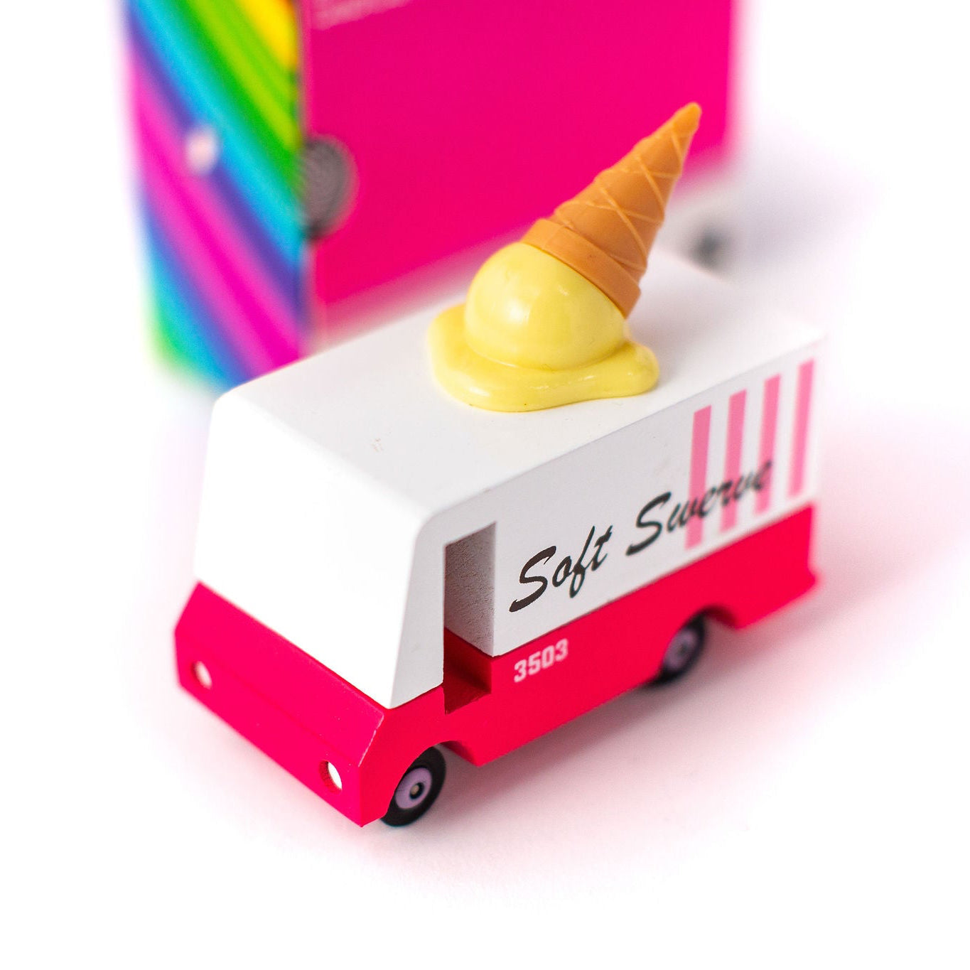 Toy ice cream truck with a cone on top against a white background