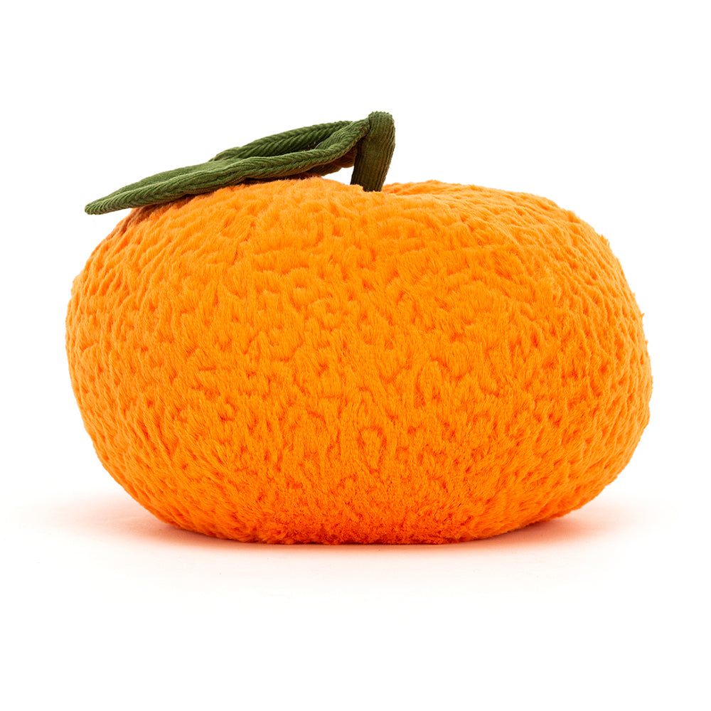 The back plush toy in the shape of an orange. The orange, which is also the colour orange is textured and has a green stem with two green leaves coming out the top of it. This is against a white background. 