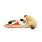 The side of a plush toy in the shape of a pizza slice that has two brown arms coming out either side of the beige crust. The crust has a black smile with two black eyes, which appear to be beads. The toppings of the pizza include mozzarella which is white, basil which is green and olives which are black. These are on top of red sauce. This is against a white background. 