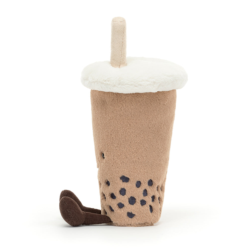 Soft Jellycat Amuseable Bubble Tea plush toy with a smiley face, fuzzy straw, corduroy legs, and velvety boba balls in a beige cup. Shown from the right hand side