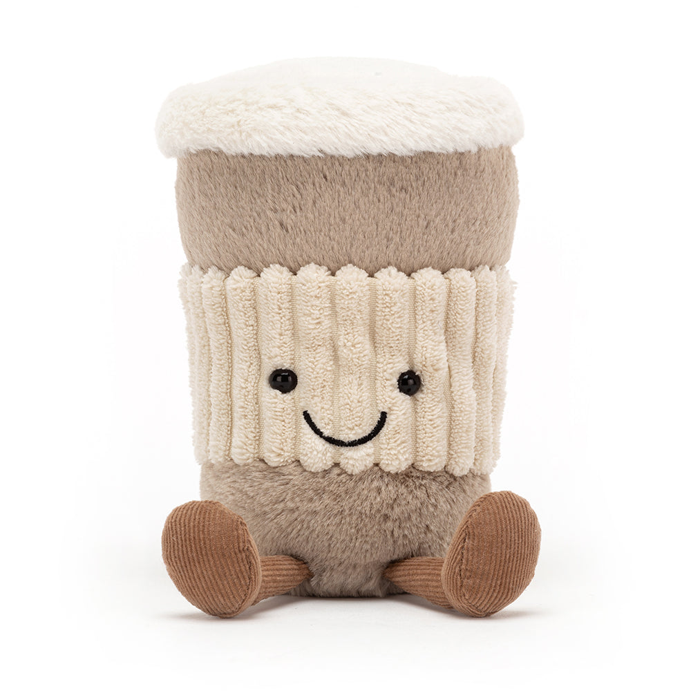 A soft, plush coffee cup with a friendly face and textured lid, featuring a little handle. The coffee cup is part of the Jellycat Amusables collection, designed to resemble a to-go coffee cup, and has a cozy, cuddly appearance. Shown from the front