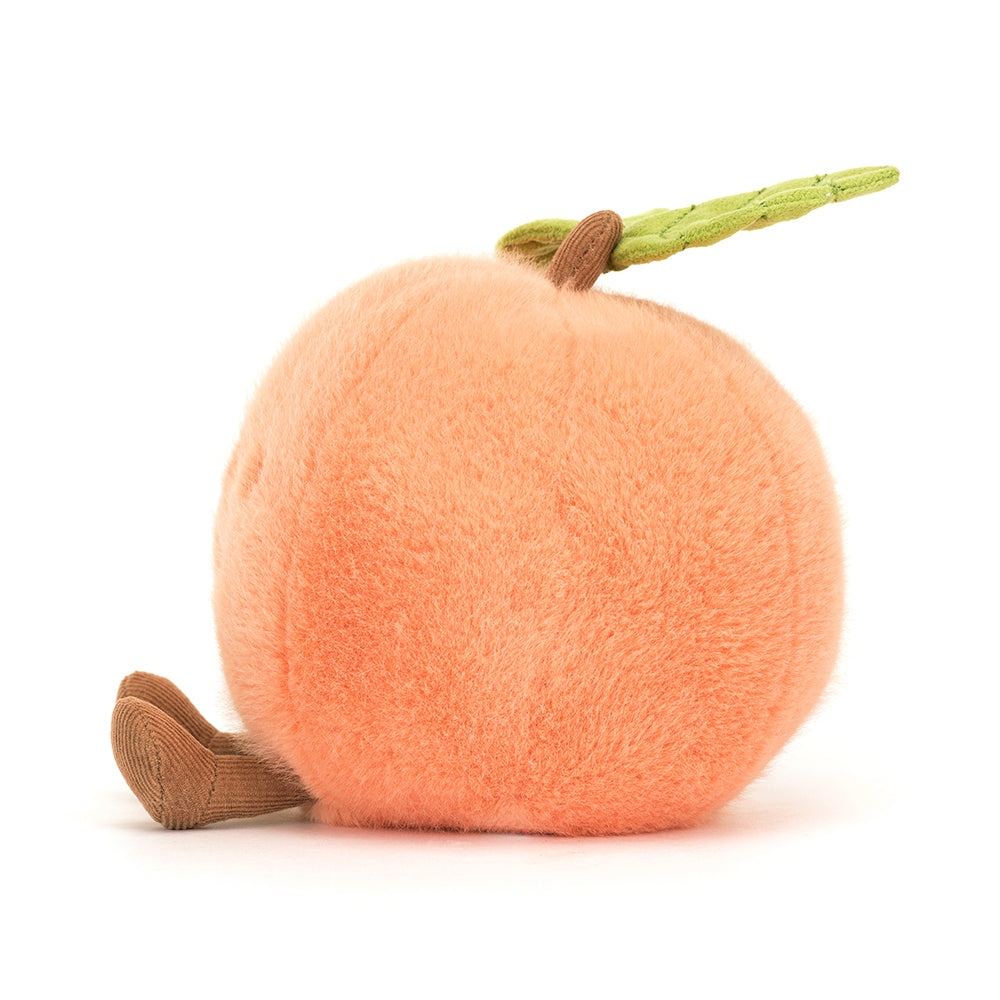 Jellycat Amuseables Peach plush toy with soft halo fur, a smiling face, side dimple, corduroy boots, stitched leaf, and corded stalk, adding a touch of playful charm. Shown from a side view