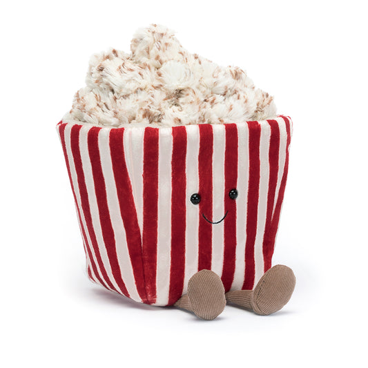 A whimsical Jellycat Amuseables Popcorn plush toy featuring a red-and-white striped tub with a smiling embroidered face, overflowing with fluffy, buttery popcorn pieces on top, and playful brown corduroy legs. Perfect for movie night vibes.