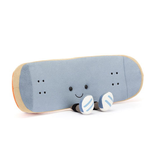 Jellycat Amuseables Sports Skateboarding plush toy in the shape of a skateboard, featuring blue suedette material, beige edging, and orange detailing, resting on soft charcoal wheels.