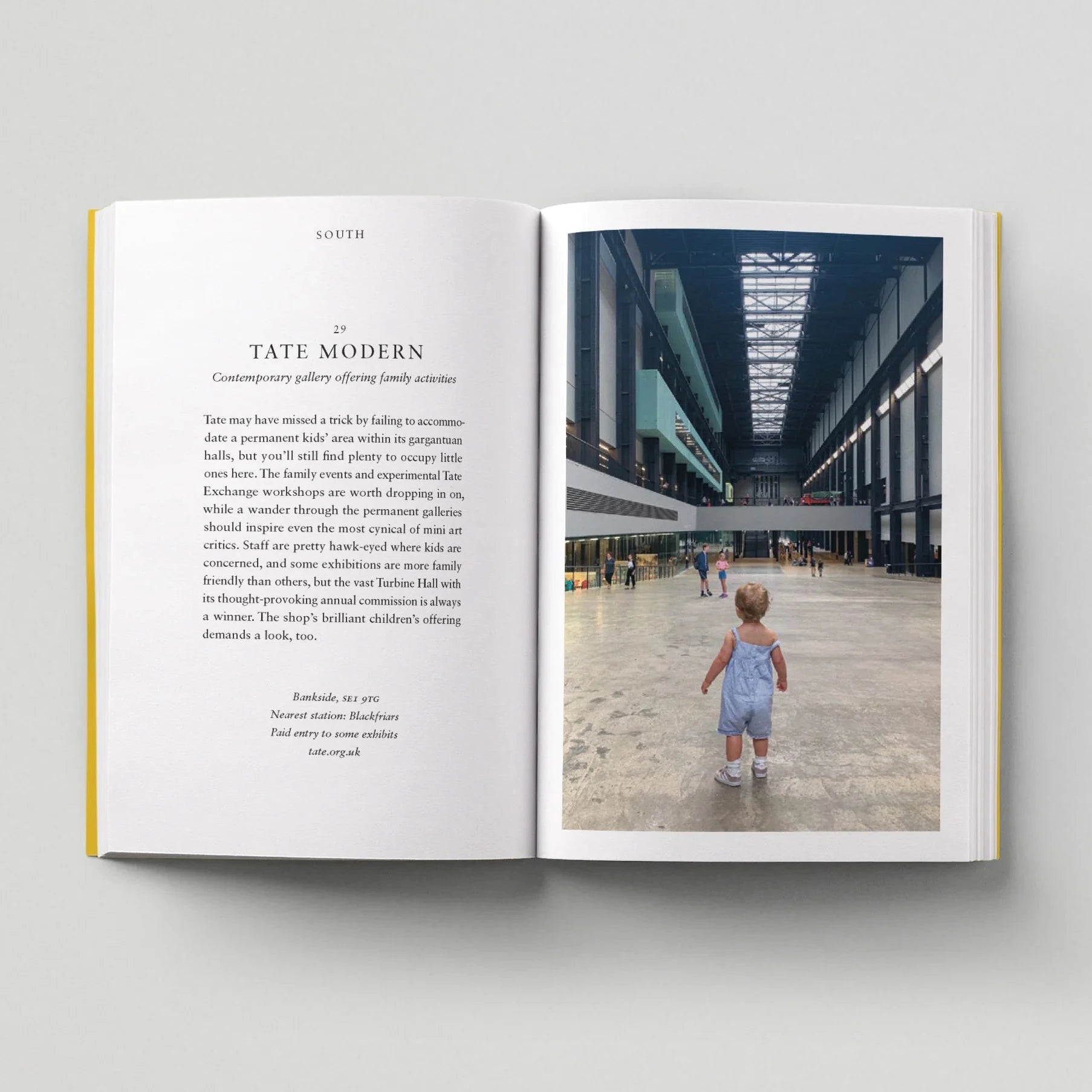 Open book showing a photo of a child walking in a modern building with text on the left page.