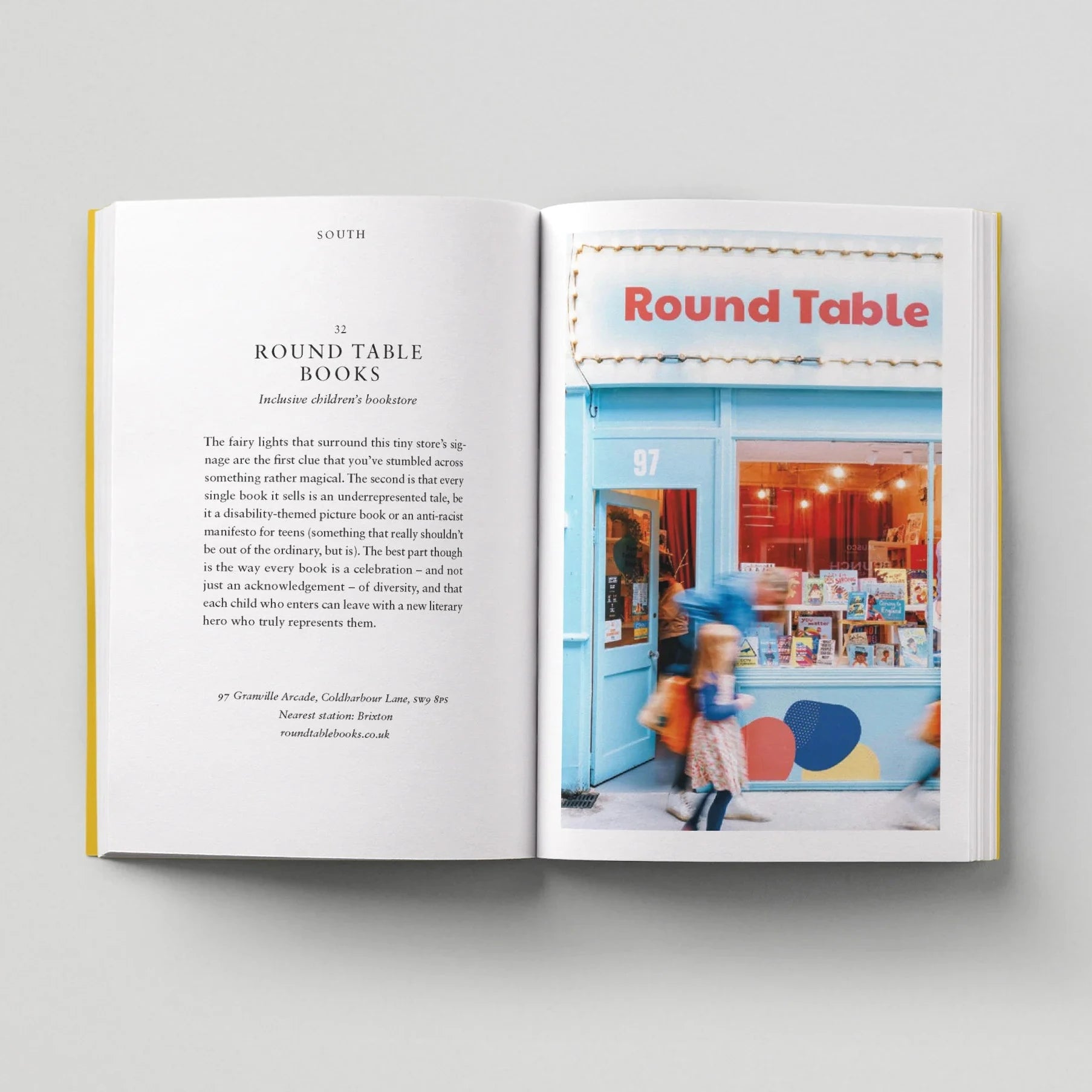 Open book showing a page with text and an image of a bookstore named 'Round Table'.