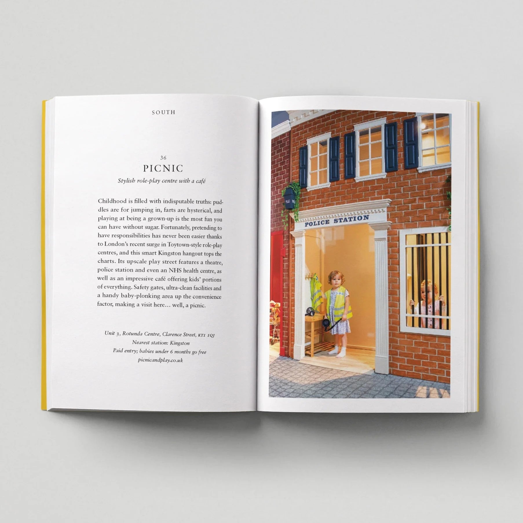Open book showing a page with text and a color illustration of a police station.