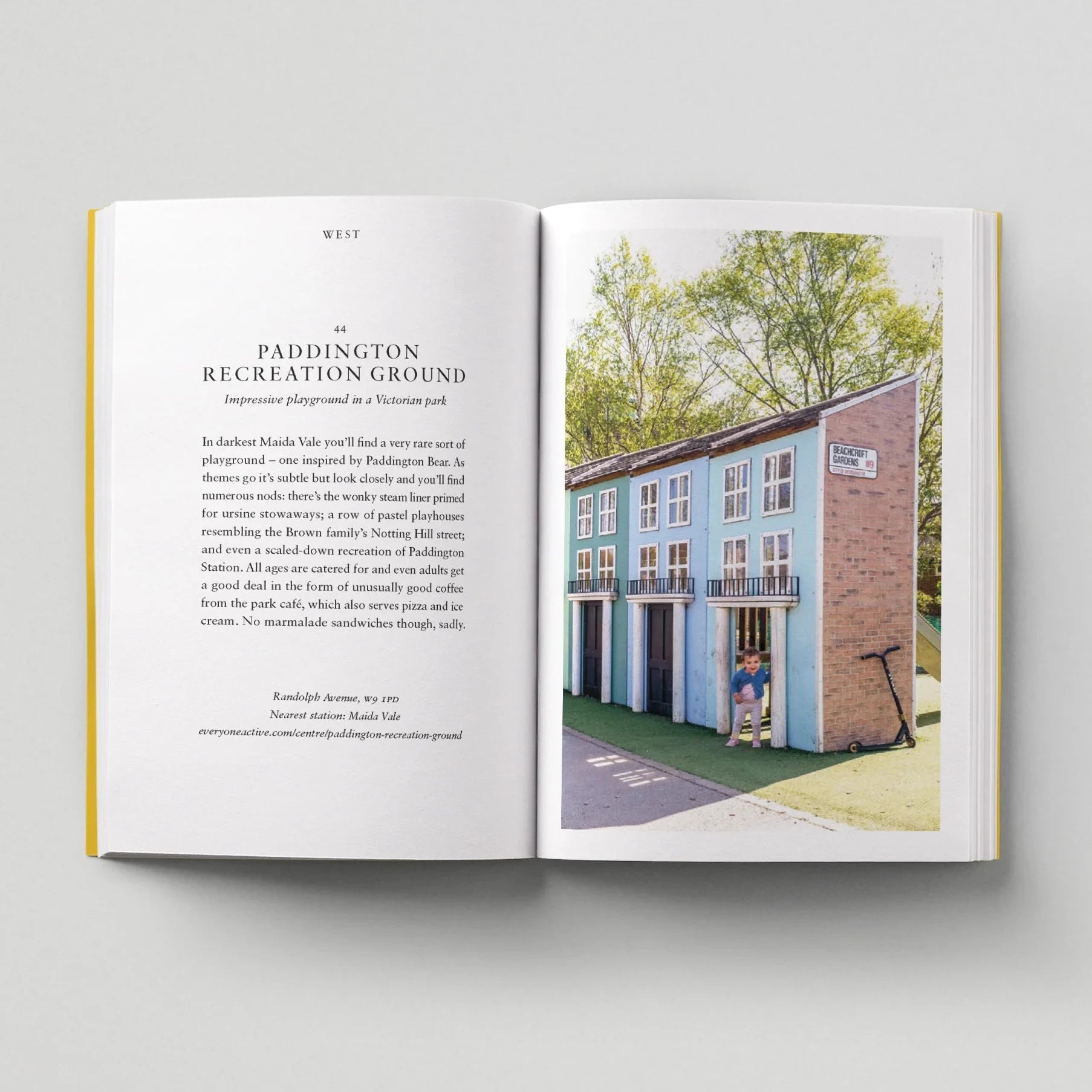 Open book showing a photograph of a playground with text on a light gray background