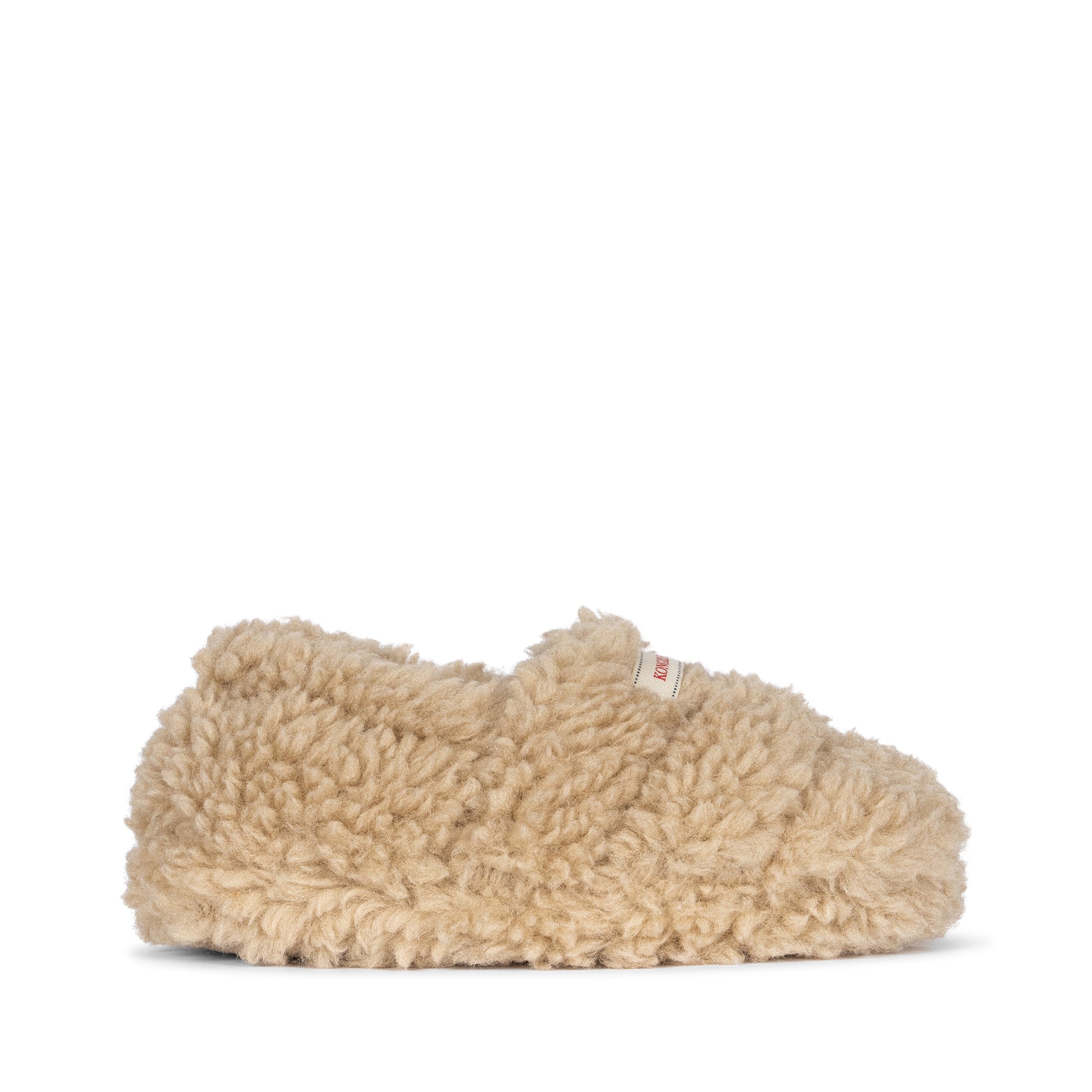 A side view of the Konges Sløjd Globe Footies in cream, showcasing the plush sherpa texture and minimalist silhouette.