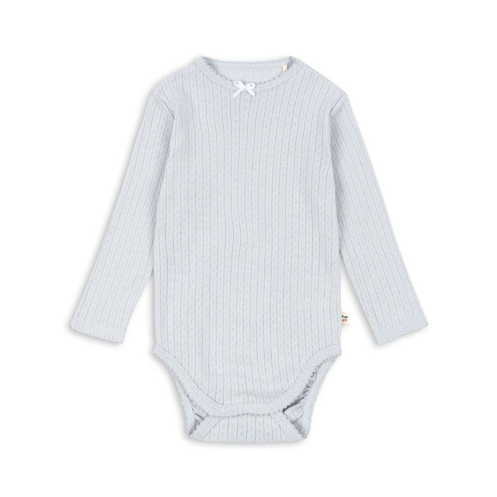 A delicate long-sleeved baby bodysuit in soft gray dawn with a pointelle knit pattern, featuring a small bow detail at the neckline.