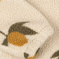 Close-up of the Konges Sløjd Mon Grand Citron Jody Jacket's fabric – A detailed look at the soft sherpa fleece texture with a yellow lemon and green leaves woven into the fabric.