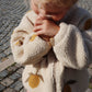 A close-up of a child wearing the soft fleece jacket with a lemon pattern, standing outdoors.