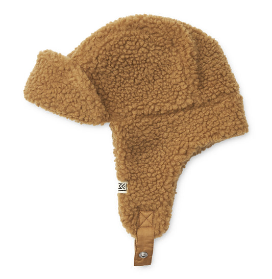 Liewood Golden Caramel Bravo Pile Hat for children, featuring soft fleece lining, protective earflaps, and adjustable snap-button straps, displayed on a neutral background.