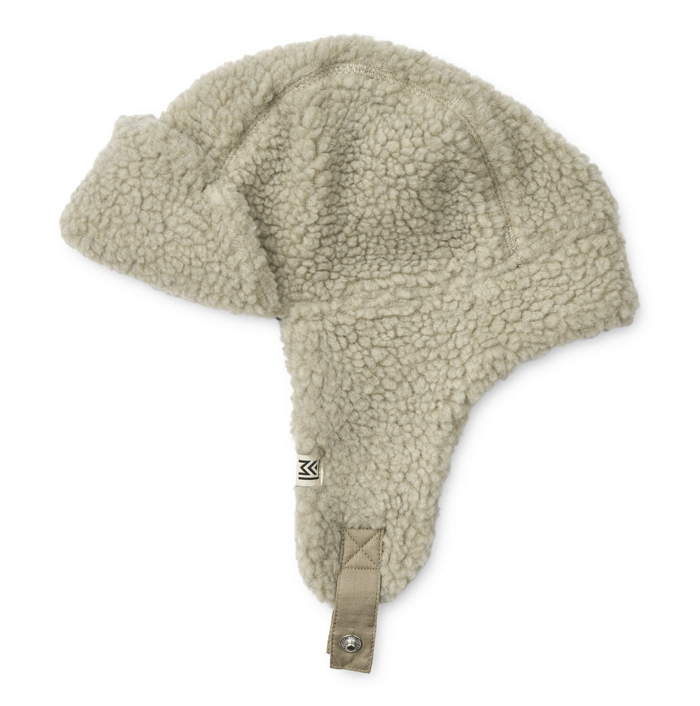 Liewood MistBravo Pile Hat for children, featuring soft fleece lining, protective earflaps, and adjustable snap-button straps, displayed on a neutral background.