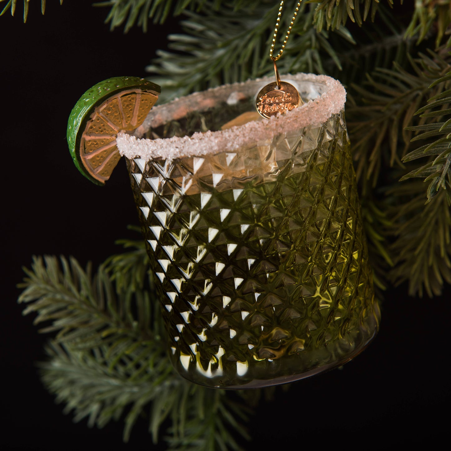 Hand-blown glass Margarita ornament featuring frosty ice, a salted rim, and a hand-painted lime wedge garnish, hanging on a christmas tree branch