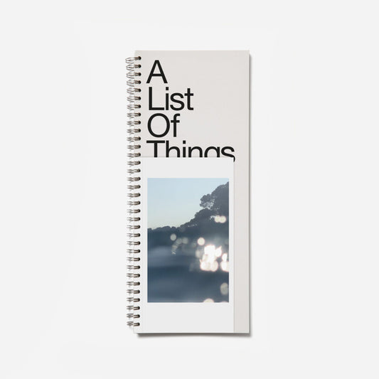 Notebook titled 'A List Of Things' with a scenic cover on a white background