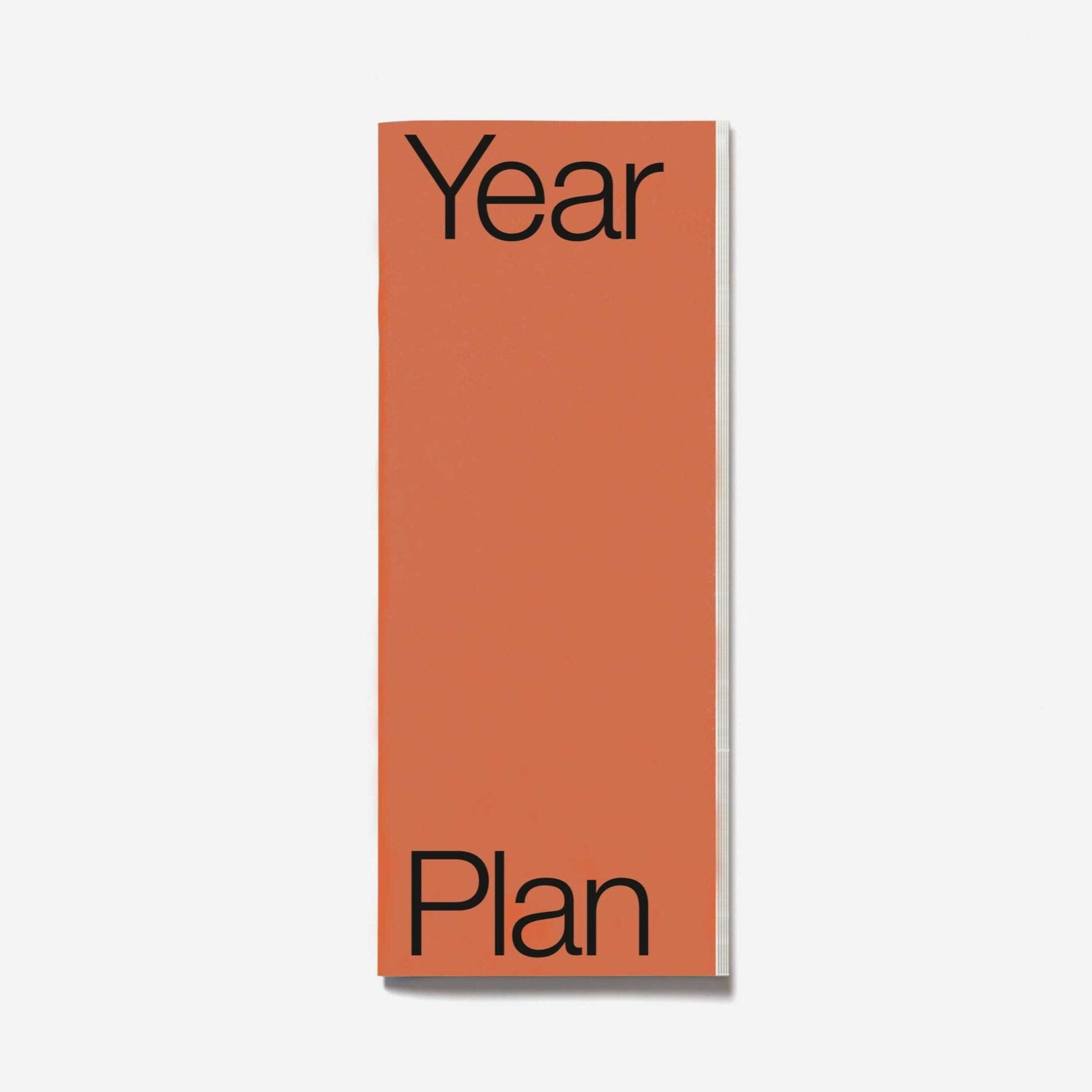 Orange planner with 'Year Plan' text on a white background