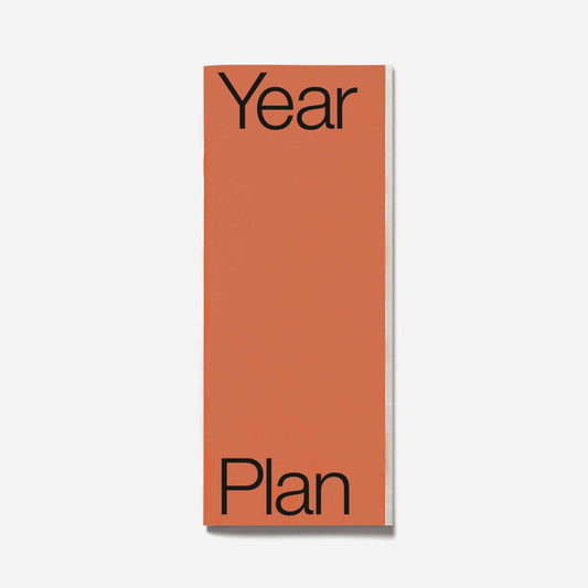 Orange planner with 'Year Plan' text on a white background