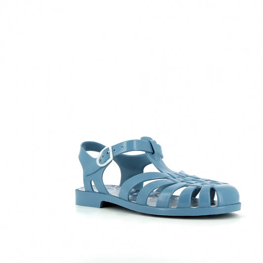 A profile shot of a single denim blue Méduse Sundana sandal with a comfortable, flexible sole and a secure ankle strap.