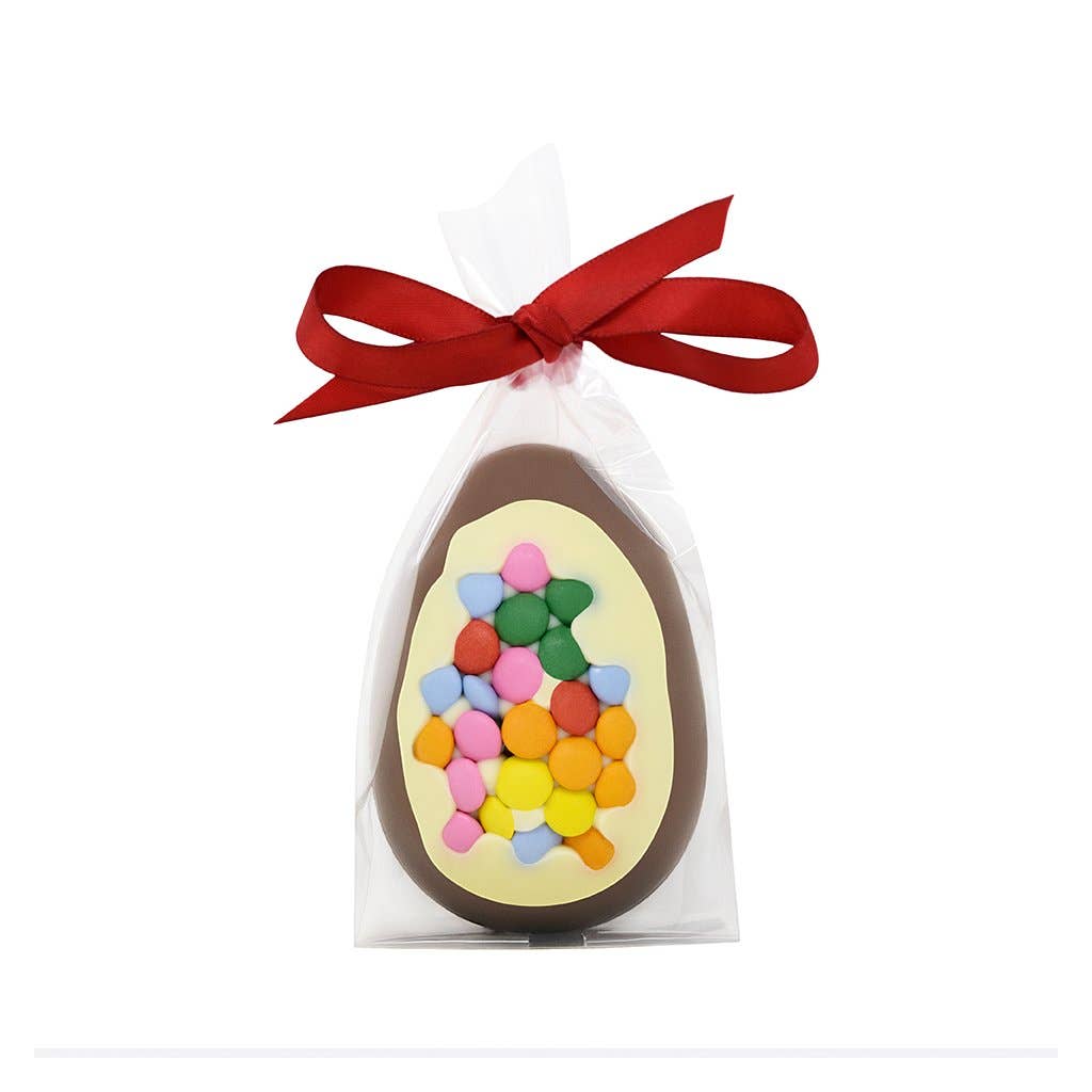 at milk chocolate easter egg with a white chocolate front studded with lots of miniature smarties. It is in a cellophane bag and tied with a red ribbon