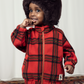 A child in the Mini Rodini children bright red with large check pattern fleece jacket, with a gold plated zip and two side pockets and a high neck