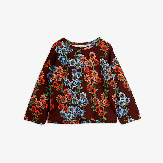 a Mini Rodini burgundy red long sleeve t-shirt with a daiy all over print in red, pink and blue with green stems