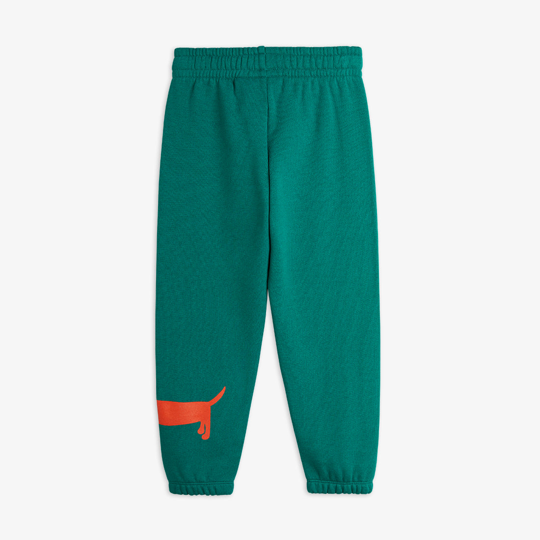 a pair of teal green mini rodini sweatpants with a printed red sausage dog on the bottom of the left leg. with an elasticated waistband and cuffs at the ankles