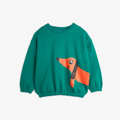 a pair of teal green mini rodini sweatshirt with a printed red sausage dog on the left side of the sweatshirt. with an elasticated waistband and cuffs on the sleeves