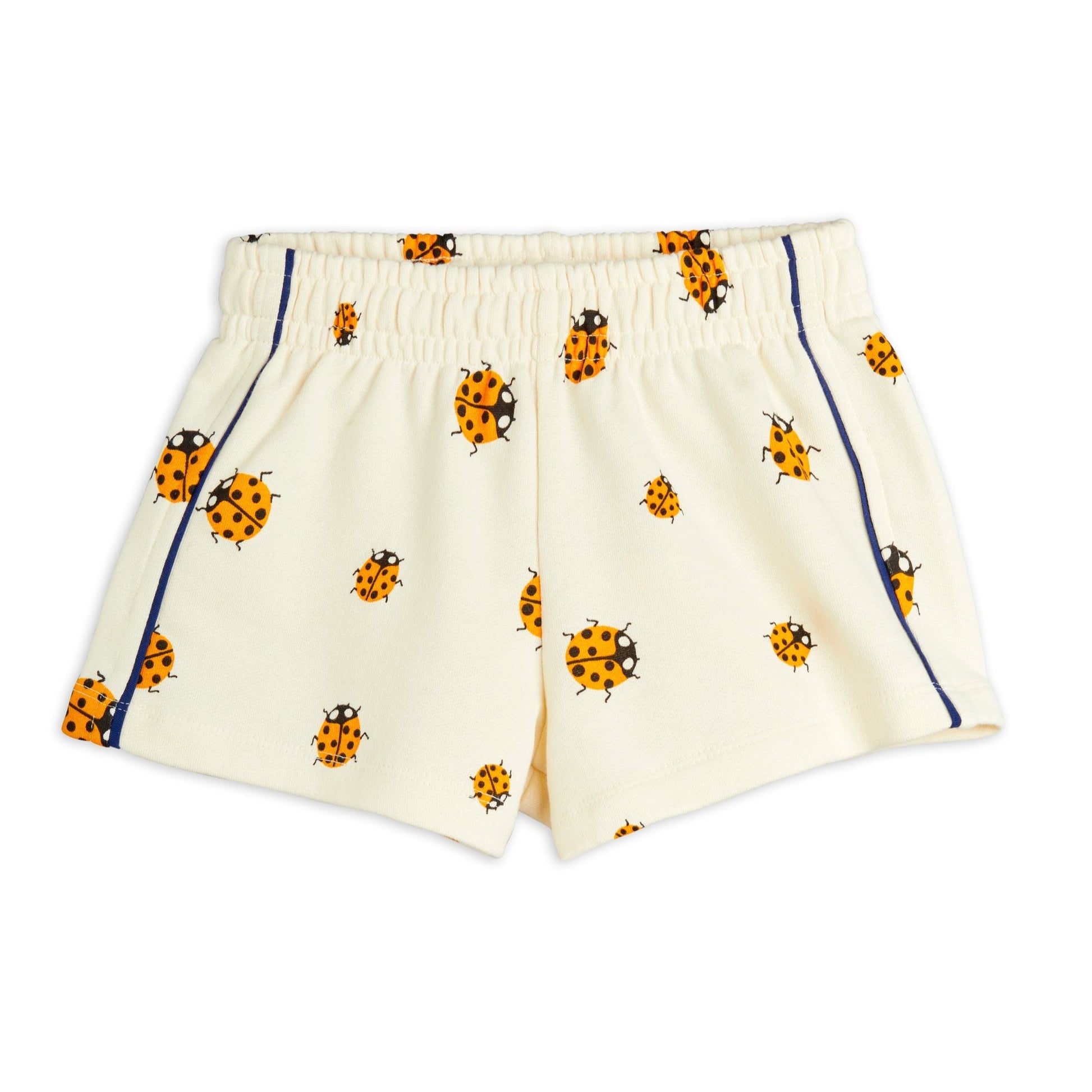 A pair of children's cream-coloured shorts featuring an all-over orange and black ladybird print. Designed with an elasticated waistband and navy blue piping along the sides for a sporty touch.