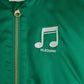 A close-up view of the Mini Rodini Note Chenille Satin Baseball Jacket in vibrant green, featuring an embroidered white musical note and "M. Rodini" text on the chest. The gold YKK zipper adds a sleek finish.