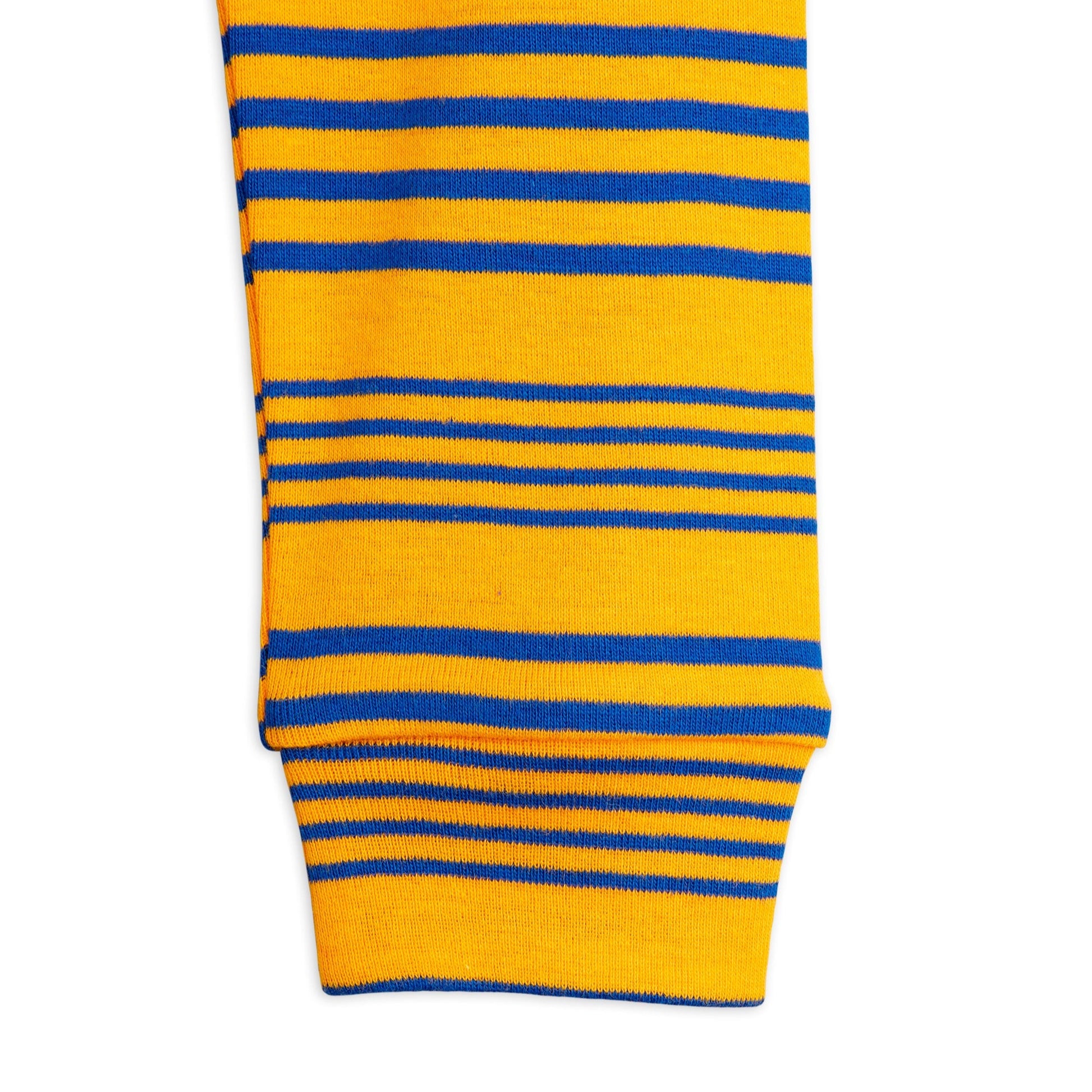 Zoomed-in view of the ribbed cuff on the Mini Rodini striped leggings, showcasing the elasticated fit and alternating blue and yellow stripe pattern.