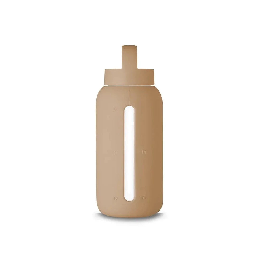 A matte Silicone covered glass bottle, with a window to see the drink on the inside, in a cream beige colour with a plastic screw top circular lid with a handle