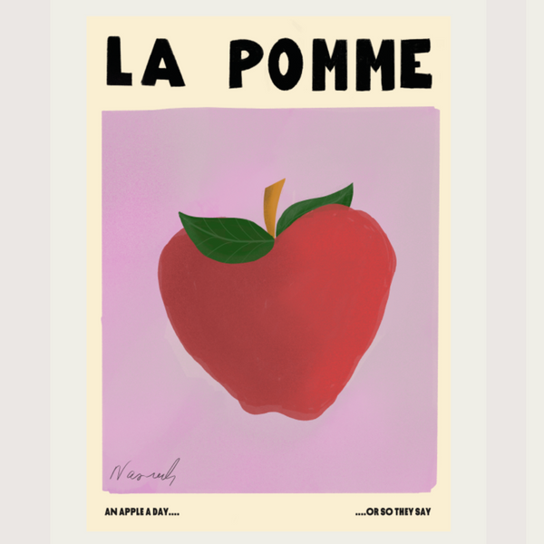 A Natalia Bagniewska Pomme print. The background is pink. It says “La Pomme” which means the apple in French. The apple is red in colour and then leaves are green. The stem is brown. Beneath the pink background, in black, on the left hand side it says An Apple A Day... and on the right it says ...Or So They Say