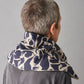 Person wearing a navy and beige patterned wheat bag on a plain background