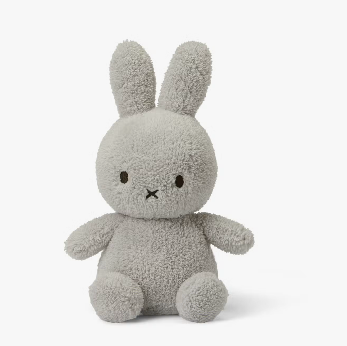 A Miffy Terry soft toy in the colour light grey. This Miffy has black eyes and mouth. Miffy is 23 cm in height. The background is white. 