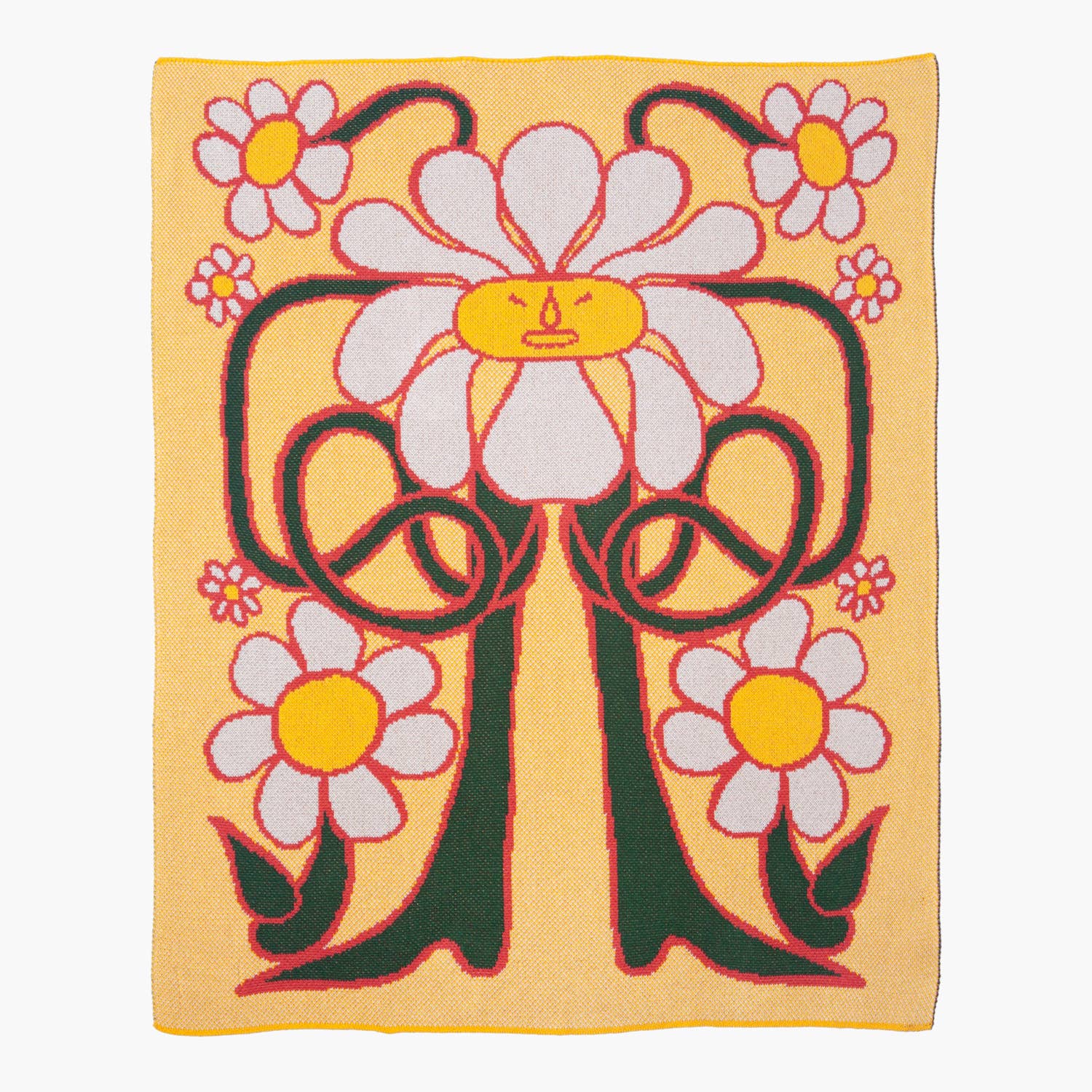 A knitted blanket featuring a cheerful daisy design with bold green stems and vibrant yellow accents, displayed flat against a white background.