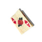 An Ace of Hearts playing card-shaped hair claw with a marbled ivory texture, red heart symbols, and a central rose motif. The delicate gold detailing enhances the design, while the clip casts a subtle shadow against a white background.