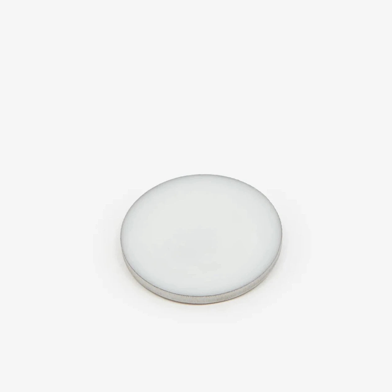 A circular pot of the perfume balm against a white background. 