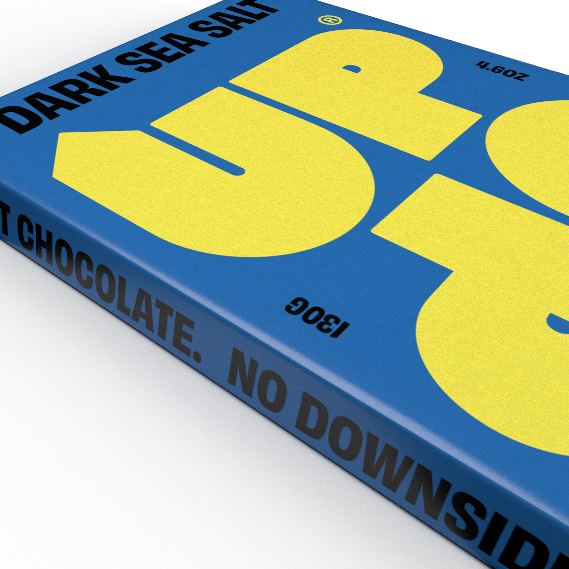 Close up of UP UP Dark Sea Salt Chocolate with blue and yellow packaging on a white background