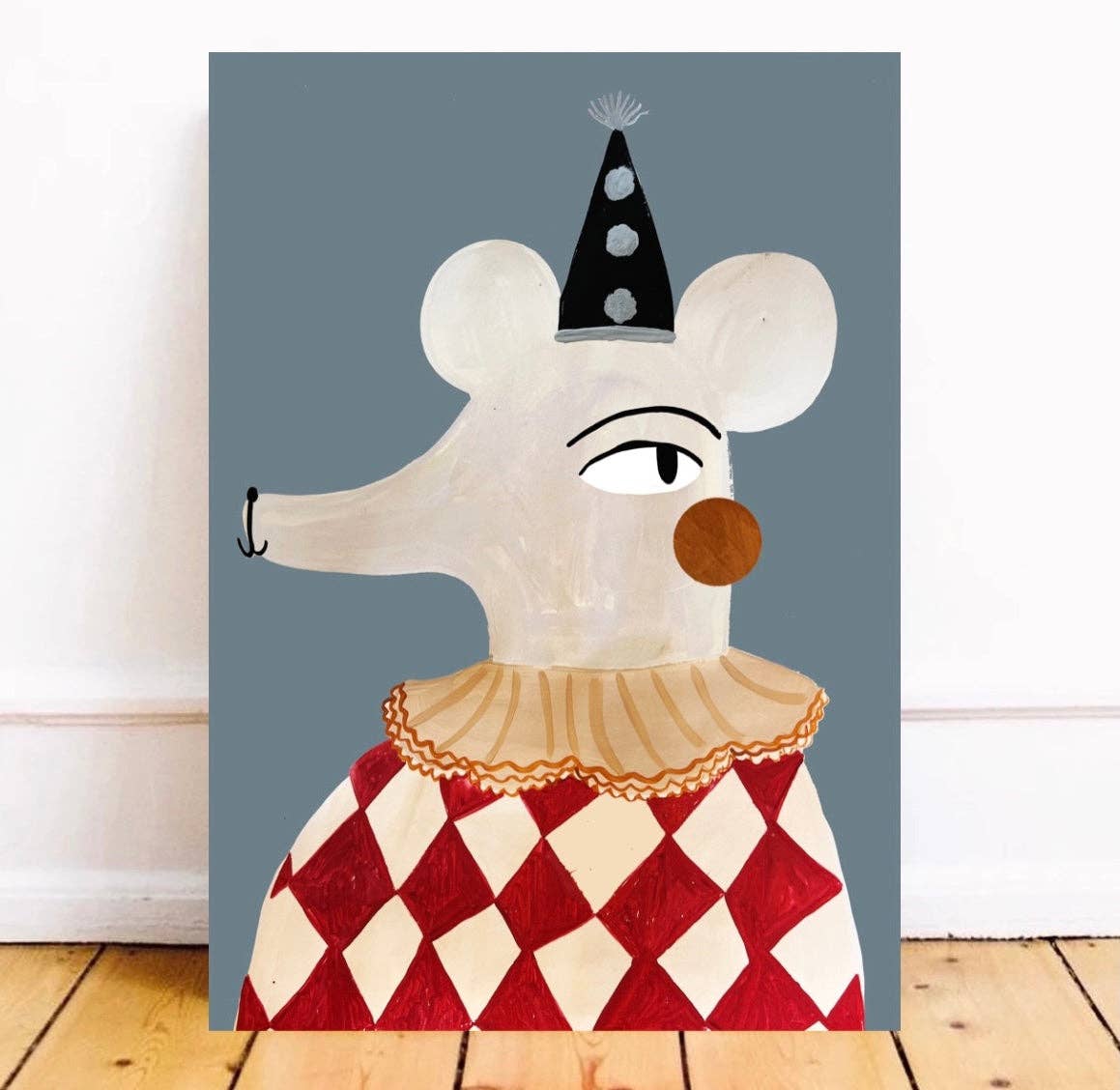 Circus Mouse art print featuring a light grey mouse in a red harlequin outfit with a yellow ruffle and dark party hat with pom-poms, set against a blue background, perfect for children's spaces.