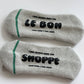 Two gray socks with text on a white background