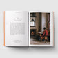 Open book showing a page with text and a photograph of a person with a dog in a room.
