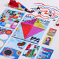 Colorful art supplies including kites and design sheets on a white background